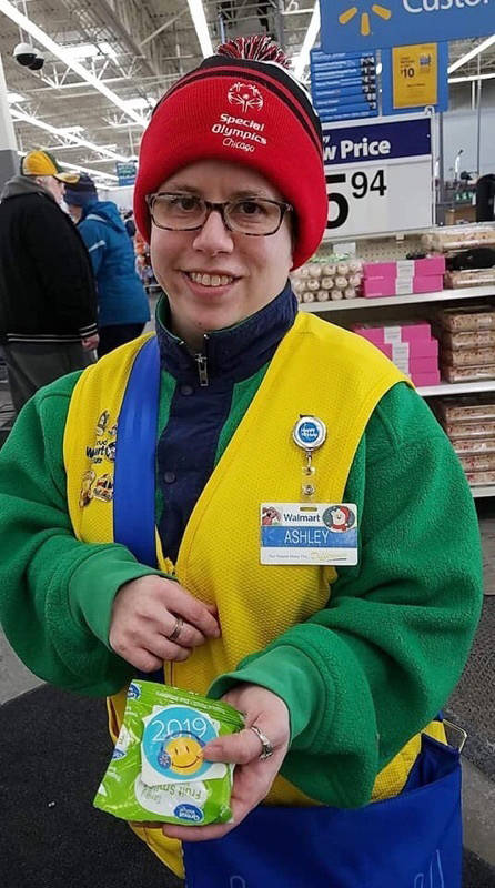 In this Feb. 21, 2019 photo provided by Tamara Ambrose, Ashley Powell poses for a photo at a Walmart store in Galena, Ill. Powell and other greeters with disabilities are threatened with job loss ...
