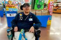 In this April 21, 2018 photo provided by Rachel Wasser, Walmart greeter John Combs works at a Walmart store in Vancouver, Wash. Combs, who has cerebral palsy, and other greeters with disabilities ...