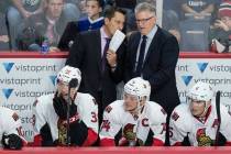 Ottawa Senators head coach Guy Boucher, left, speaks with assistant coach Marc Crawford during the third period of a preseason NHL hockey game in Halifax, Nova Scotia on Sept. 26, 2016. (Darren Ca ...