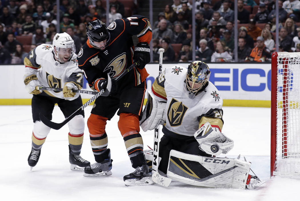 Vegas Golden Knights goaltender Marc-Andre Fleury, right, stops a shot next to Anaheim Ducks' Ryan Kesler (17) and Golden Knights' William Karlsson, left, during the second period of an NHL hockey ...