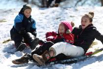 Lincoln Warnick, 10, from left, with his sisters Abby, 6, and Lydia, 12, play in the snow at Willows Park in Las Vegas, Friday, Feb. 22, 2019. (Erik Verduzco/Las Vegas Review-Journal) @Erik_Verduzco