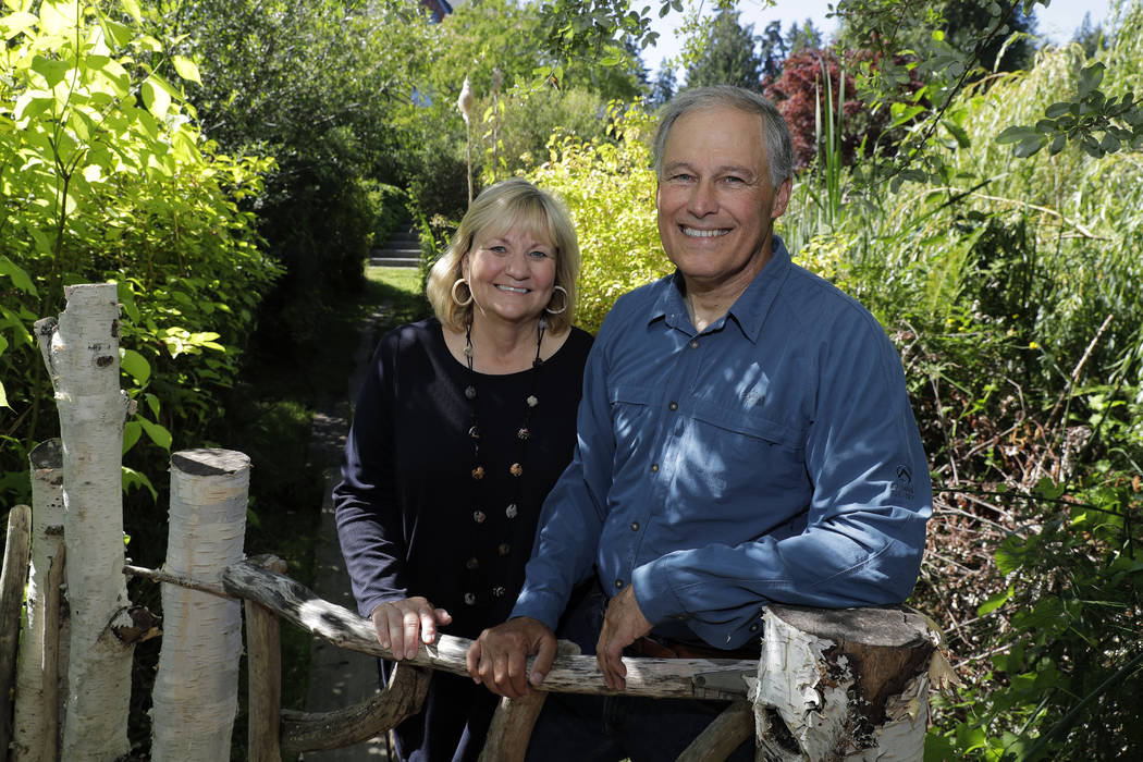 Washington Gov. Jay Inslee, with his wife, Trudi Inslee, on a path near their home on Bainbridge Island, Wash. Inslee is adding his name to the growing 2020 Democratic presidential field. (Ted S. ...