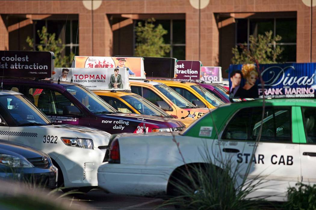 Cabs are parked outside of Grant Sawyer Building Monday, March 30, 2015, in Las Vegas. Southern Nevada taxi drivers and Uber supporters were among those who attended a hearing to discuss proposed ...