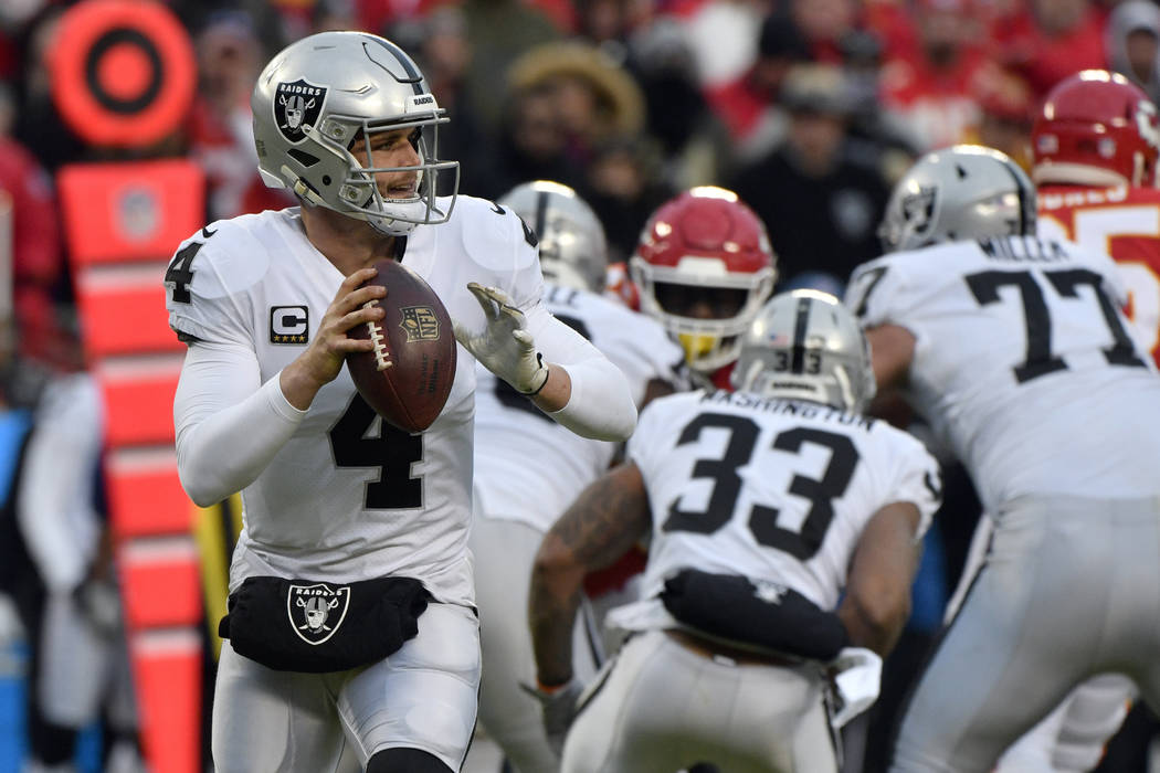 Oakland Raiders quarterback Derek Carr (4) looks for a receiver during the first half of an NFL football game against the Kansas City Chiefs in Kansas City, Mo., Sunday, Dec. 30, 2018. (AP Photo/E ...