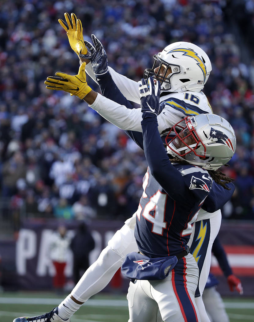Los Angeles Chargers wide receiver Tyrell Williams (16) reaches for a pass as New England Patriots defensive back Stephon Gilmore (24) defends during the first half of an NFL divisional playoff fo ...