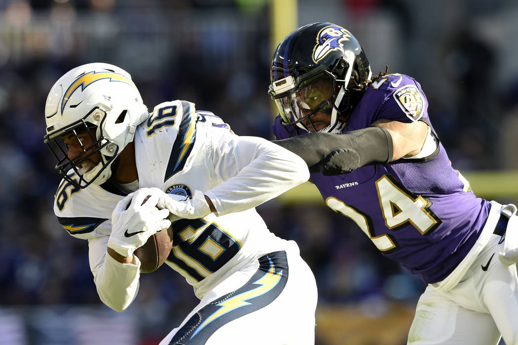 Los Angeles Chargers wide receiver Tyrell Williams, left, rushes past Baltimore Ravens cornerback Brandon Carr in the first half of an NFL wild card playoff football game, Sunday, Jan. 6, 2019, in ...