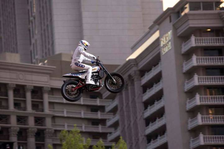Travis Pastrana jumps over the fountains at Caesars Palace on an Indian Scout FTR750 motorcycle during "Evel Live," a three-hour live tribute show to stuntman Evel Knievel, in Las Vegas on Sunday, ...