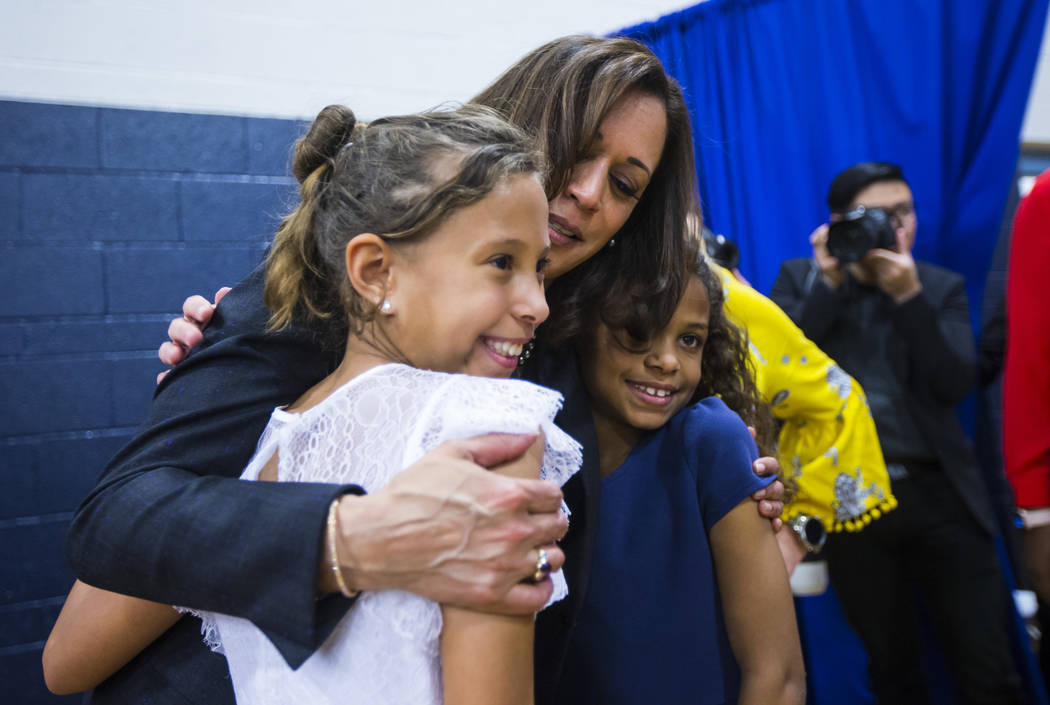 U.S. Sen. Kamala Harris, D-Calif., a Democratic presidential hopeful, talks with Sarina Pippins, 10, left, and her sister Calli, 8, during a campaign rally at Canyon Springs High School in North L ...