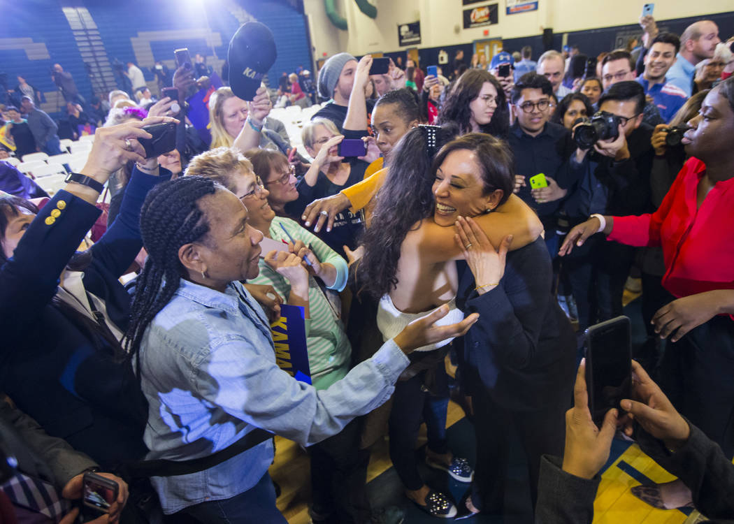 U.S. Sen. Kamala Harris, D-Calif., a Democratic presidential hopeful, right, is embraced by a supporter during a campaign rally at Canyon Springs High School in North Las Vegas on Friday, March 1, ...