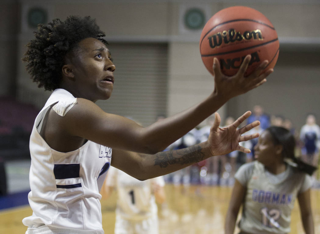 Centennial senior Quinece Hatcher (3) drives baseline past Bishop Gorman senior Aaliyah Bey (12) in the second quarter of the Class 4A girls state championship game on Friday, March 1, 2019, at Or ...