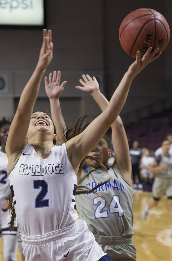 Centennial senior Melanie Isbell (2) drives past Bishop Gorman junior Bentleigh Hoskins (24) in the second quarter of the Class 4A girls state championship game on Friday, March 1, 2019, at Orlean ...