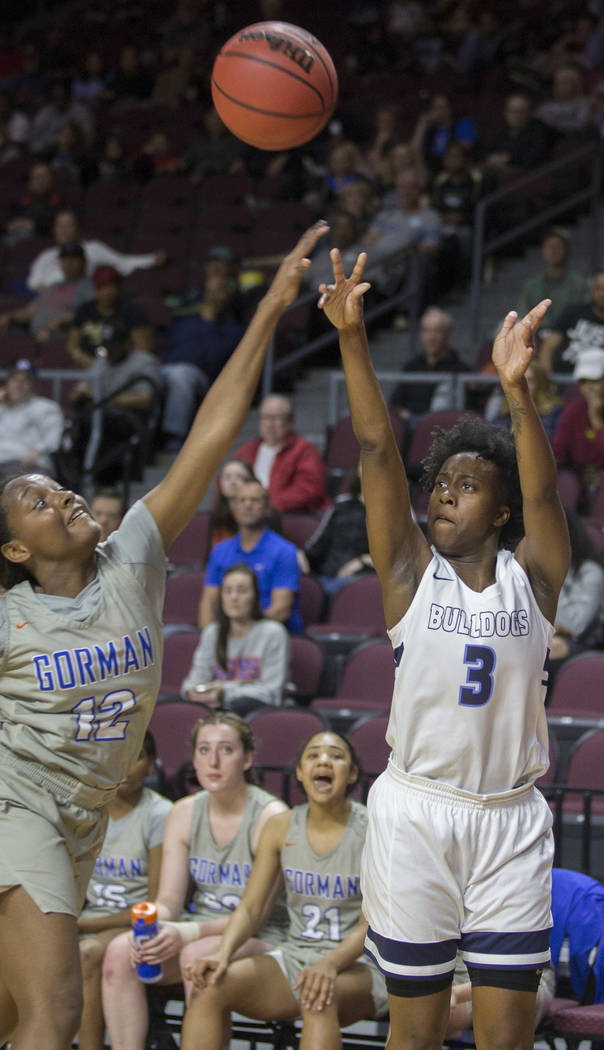 Centennial senior Quinece Hatcher (3) shoots a corner jump shot over Bishop Gorman senior Aaliyah Bey (12) in the second quarter of the Class 4A girls state championship game on Friday, March 1, 2 ...