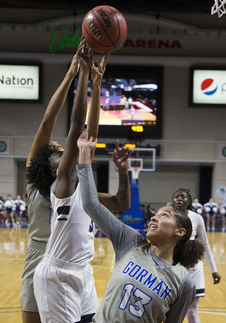 Bishop Gorman senior Georgia Ohiaeri (13) fights for a rebound with Centennial senior Quinece Hatcher (3) in the second quarter of the Class 4A girls state championship game on Friday, March 1, 20 ...