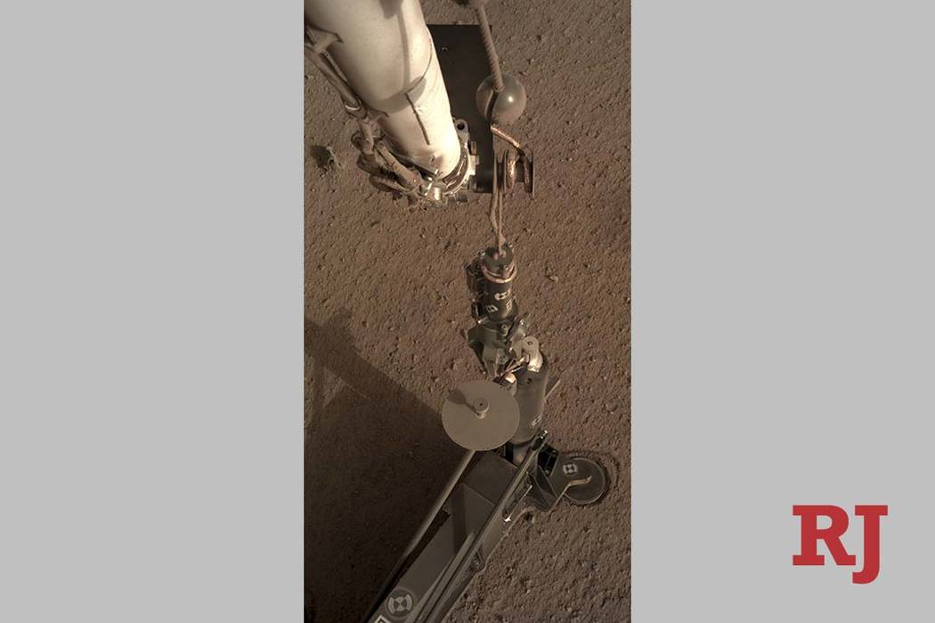 This photo provided by NASA/JPL-Caltech shows an image acquired by NASA's InSight Mars lander using its robotic arm-mounted, Instrument Deployment Camera (IDC). (NASA/JPL-Caltech via AP)