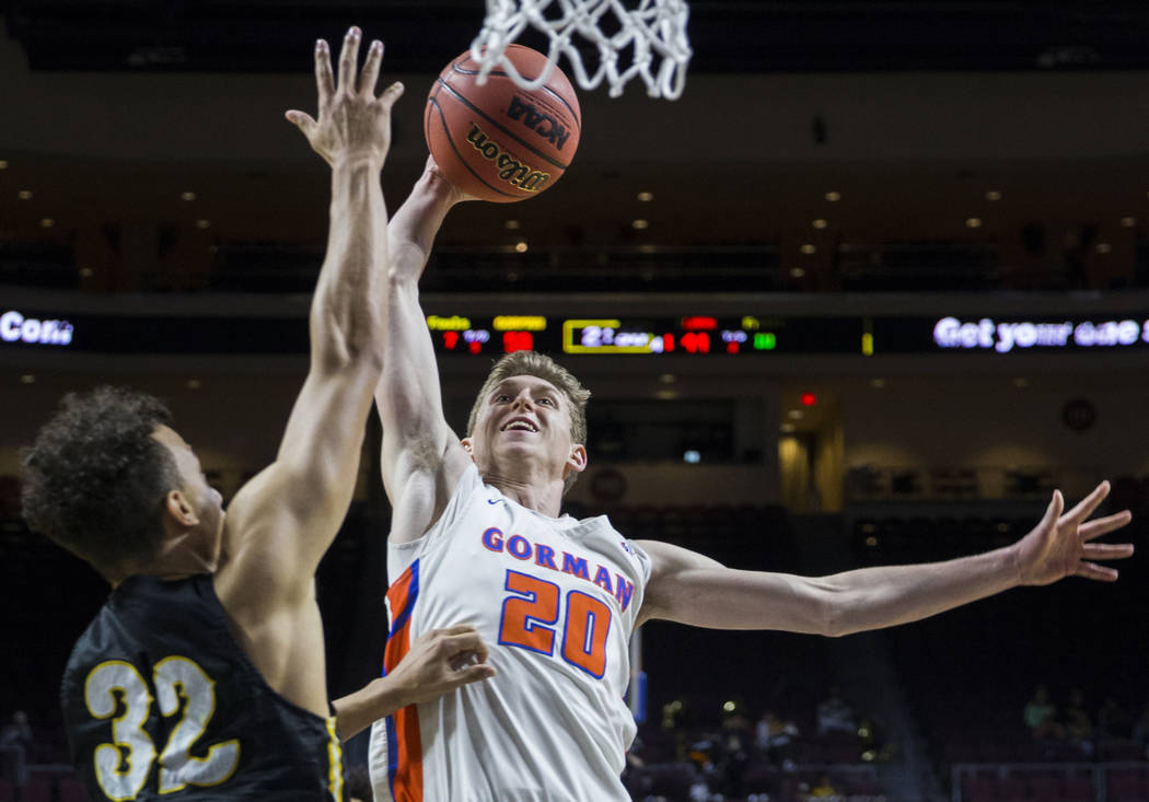 Bishop Gorman junior guard Noah Taitz (20) drives over Clark senior forward Ian Alexander (32) in the fourth quarter of the Class 4A boys state championship game on Friday, March 1, 2019, at Orlea ...