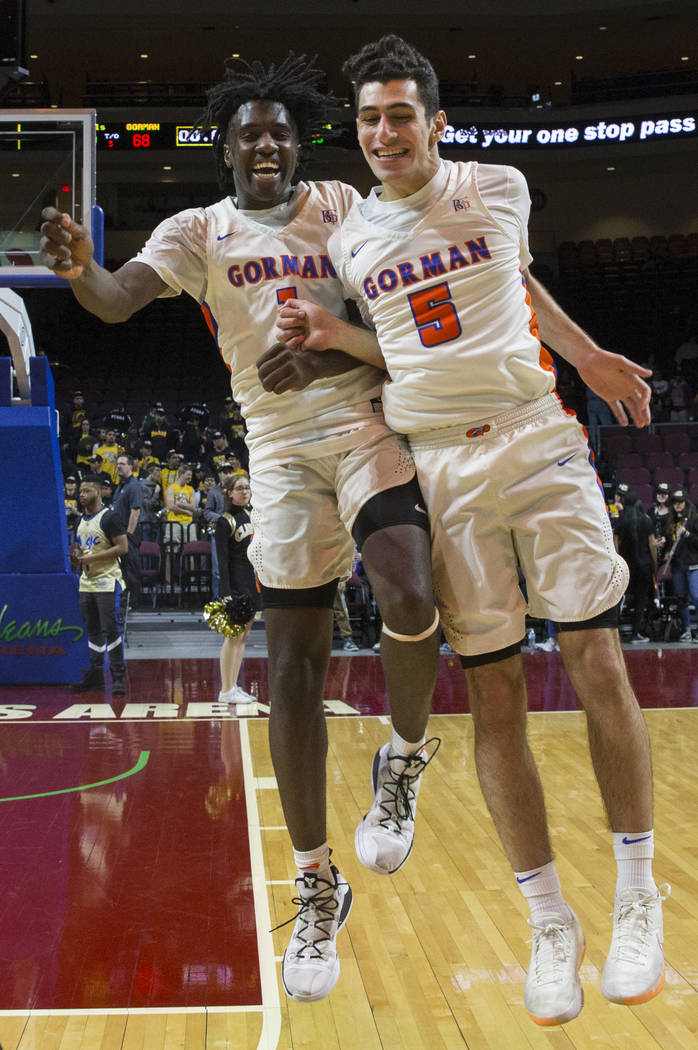Bishop Gorman sophomore guard Will McClendon (1) and junior Mohammad Judeh Khalaf (5) celebrate after beating Clark 68-60 to win the Class 4A boys state championship on Friday, March 1, 2019, at O ...