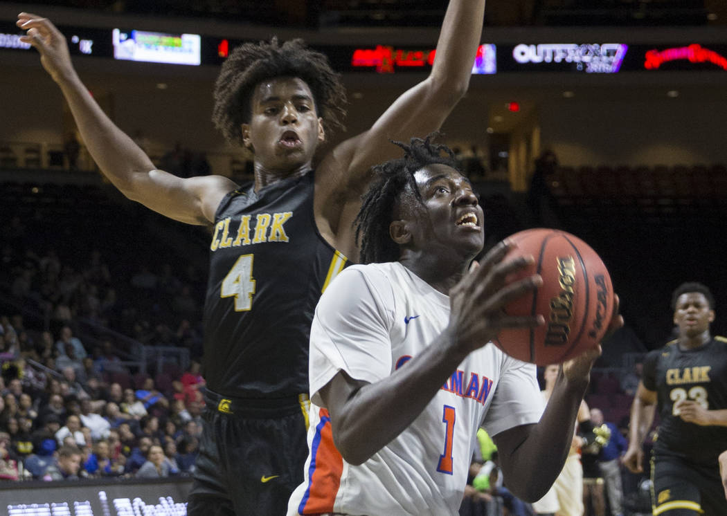 Bishop Gorman sophomore guard Will McClendon (1) drives past Clark senior guard Carlos Allen (4) in the fourth quarter of the Class 4A boys state championship game on Friday, March 1, 2019, at Orl ...