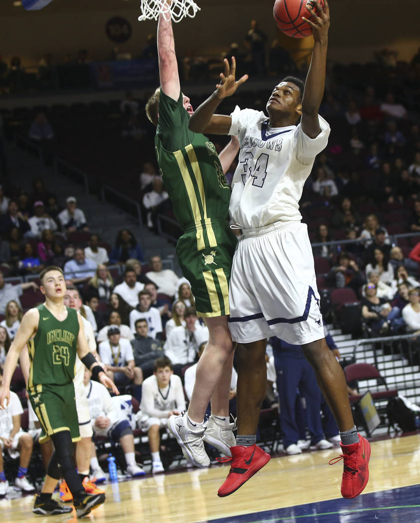 The Meadows' Obinna Ezeanolue (34) goes to the basket against Incline guard Liam Nolan-Bowers (22) during the second half of the Class 2A boys basketball state championship game at the Orleans Are ...