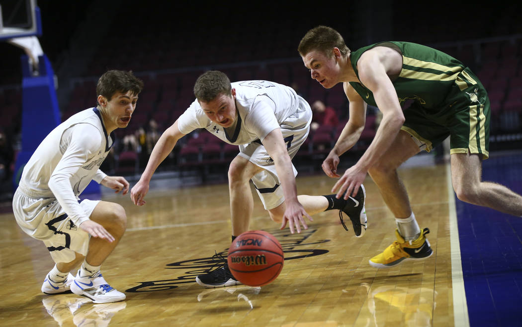 The Meadows' Noah Klein, left, and Allen Fridman, second from left, go after a loose ball against Incline's Ian Smith (5) during the second half of the Class 2A boys basketball state championship ...