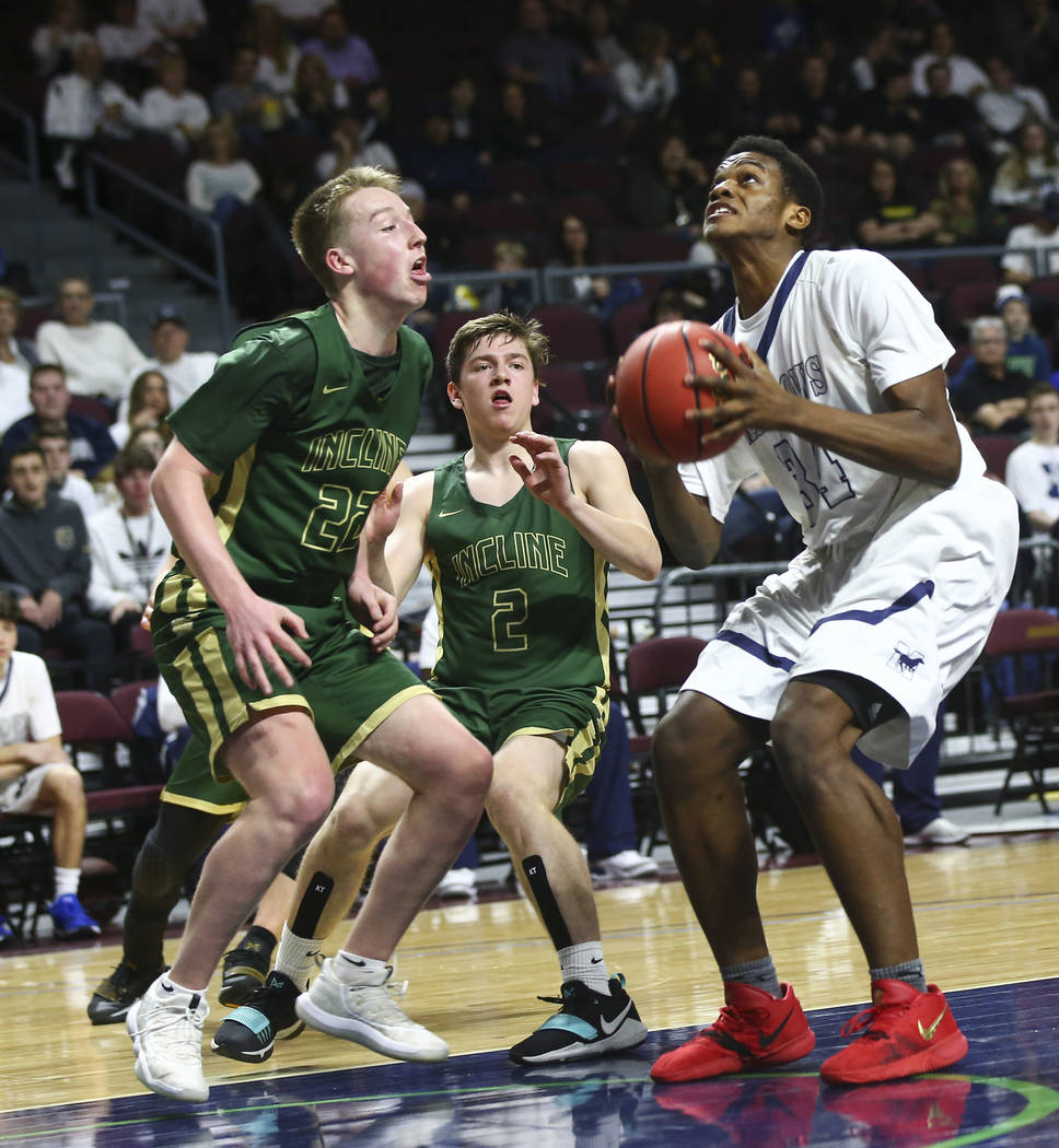 The Meadows Obinna Ezeanolue (34) looks to shoot against Incline guard Liam Nolan-Bowers (22) and Brad Rye (2) during the second half of the Class 2A boys basketball state championship game at the ...