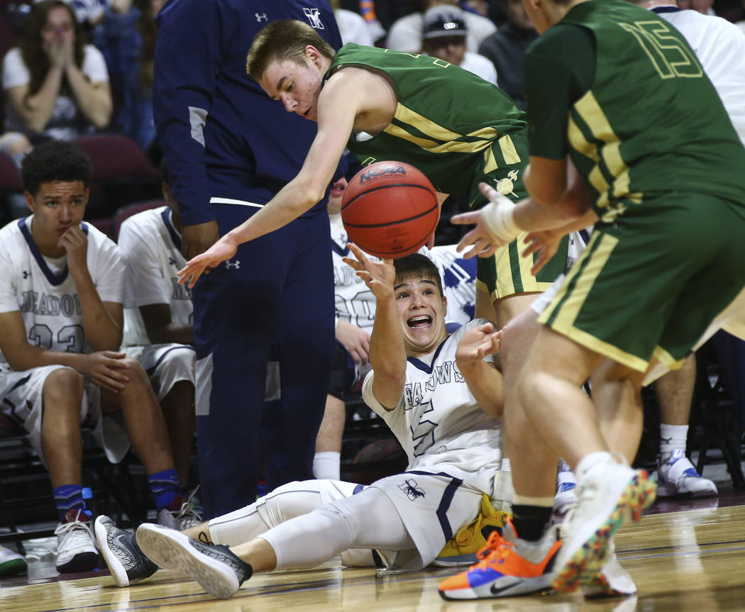 The Meadows guard Trey Covell (5) passes the ball under pressure from Incline during the second half of the Class 2A boys basketball state championship game at the Orleans Arena in Las Vegas on Sa ...