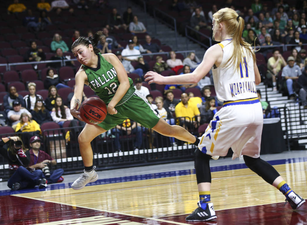 Churchill County's Alexis Jarrett (12) jumps to keep the ball in against Moapa Valley's Kaitlyn Anderson (11) during the second half of the Class 3A girls basketball state championship game at the ...