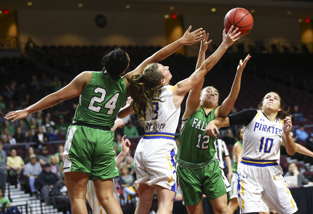 Churchill County's Leta Otuafi (24) and Alexis Jarrett (12) battle for a rebound against Moapa Valley's Ashlyn Western (3) and Peyton Schraft (10) during the second half of the Class 3A girls bask ...