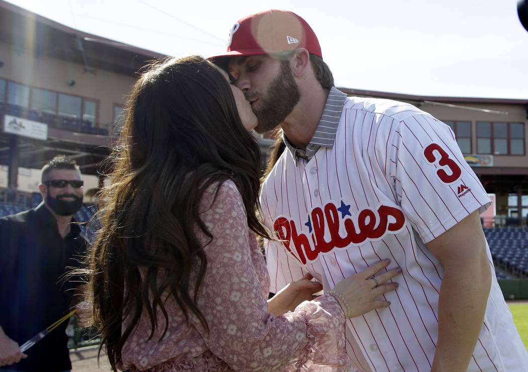 Bryce Harper, right, hugs his wife Kayla after being introduced as a Philadelphia Phillies player during a news conference at the team's spring training baseball facility, Saturday, March 2, 2019, ...