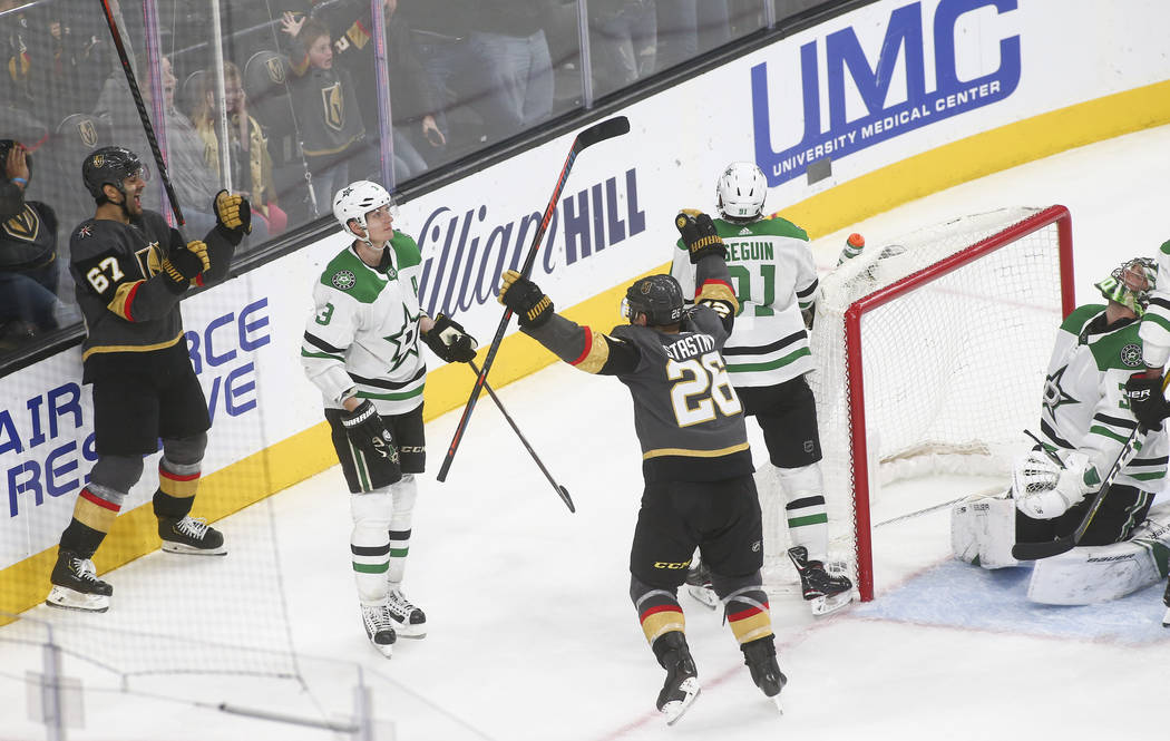Golden Knights left wing Max Pacioretty (67) celebrates his goal with Golden Knights center Paul Stastny (26) as Dallas Stars goaltender Ben Bishop, far right, reacts during the third period of an ...