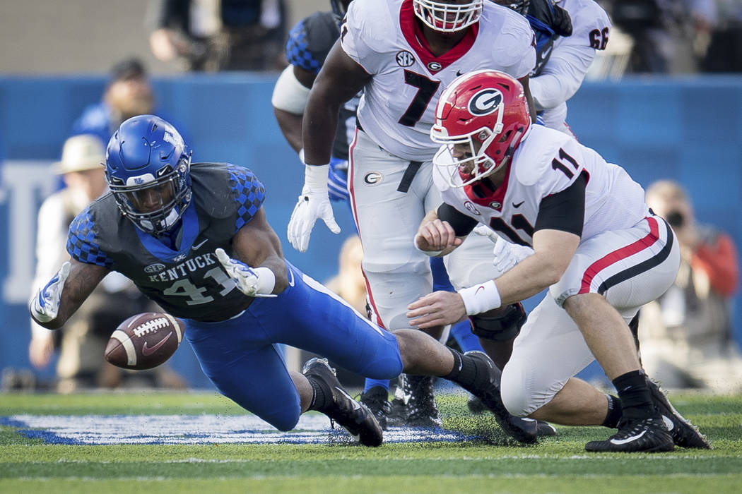 Kentucky linebacker Josh Allen (41) dives on the fumble of Georgia quarterback Jake Fromm (11) during the first half an NCAA college football game in Lexington, Ky., Saturday, Nov. 3, 2018. (AP Ph ...