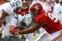 FILE - In this Nov. 17, 2018, file photo, Citadel quarterback Brandon Rainey (16) is stopped by Alabama defensive lineman Quinnen Williams (92) as he tries to carry the ball during the second half ...