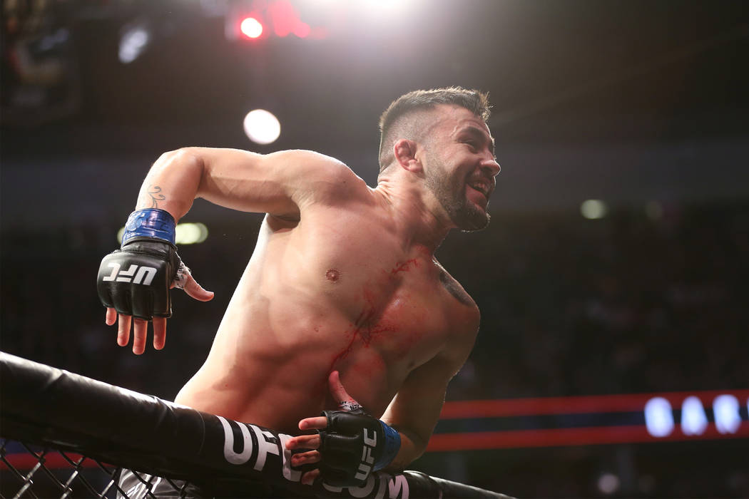 Pedro Munhoz celebrates his win against Cody Garbrandt in the bantamweight bout during UFC 235 at T-Mobile Arena in Las Vegas, Saturday, March 2, 2019. Munhoz won by way of knockout in the first r ...