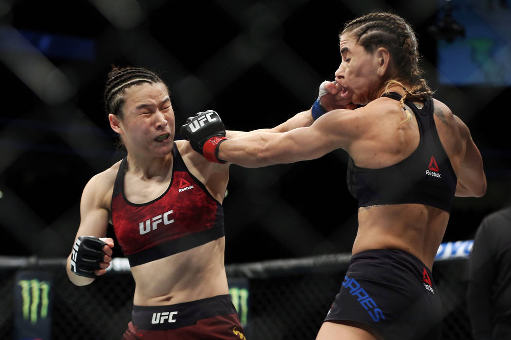 Weili Zhang, left, connects a punch against Tecia Torres in the womenÕs strawweight bout during UFC 235 at T-Mobile Arena in Las Vegas, Saturday, March 2, 2019. Zhang won by unanimous decisio ...