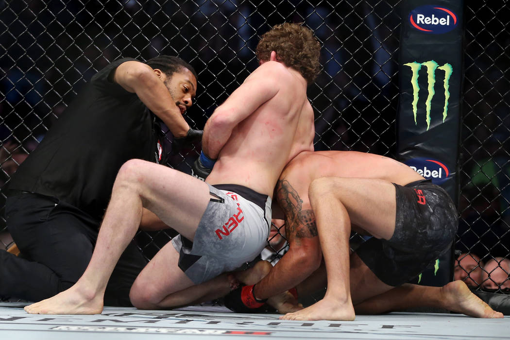 Ben Askren, center, submits Robbie Lawler in the first round of the welterweight bout during UFC 235 at T-Mobile Arena in Las Vegas, Saturday, March 2, 2019. (Erik Verduzco/Las Vegas Review-Journa ...