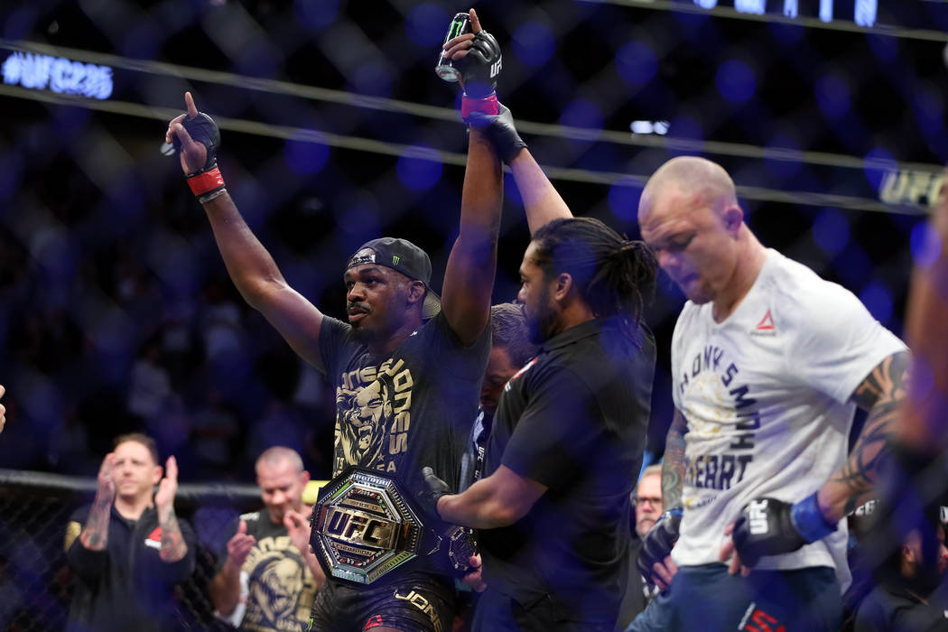 Jon Jones, left, raises his hands in victory against Anthony Smith in the light heavyweight title bout during UFC 235 at T-Mobile Arena in Las Vegas, Saturday, March 2, 2019. Jones won by unanimou ...