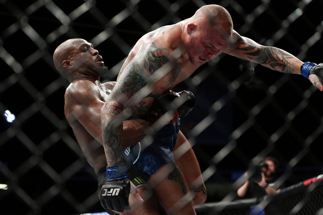 Jon Jones, left, lifts Anthony Smith in the light heavyweight title bout during UFC 235 at T-Mobile Arena in Las Vegas, Saturday, March 2, 2019. Jones won by unanimous decision. (Erik Verduzco/Las ...