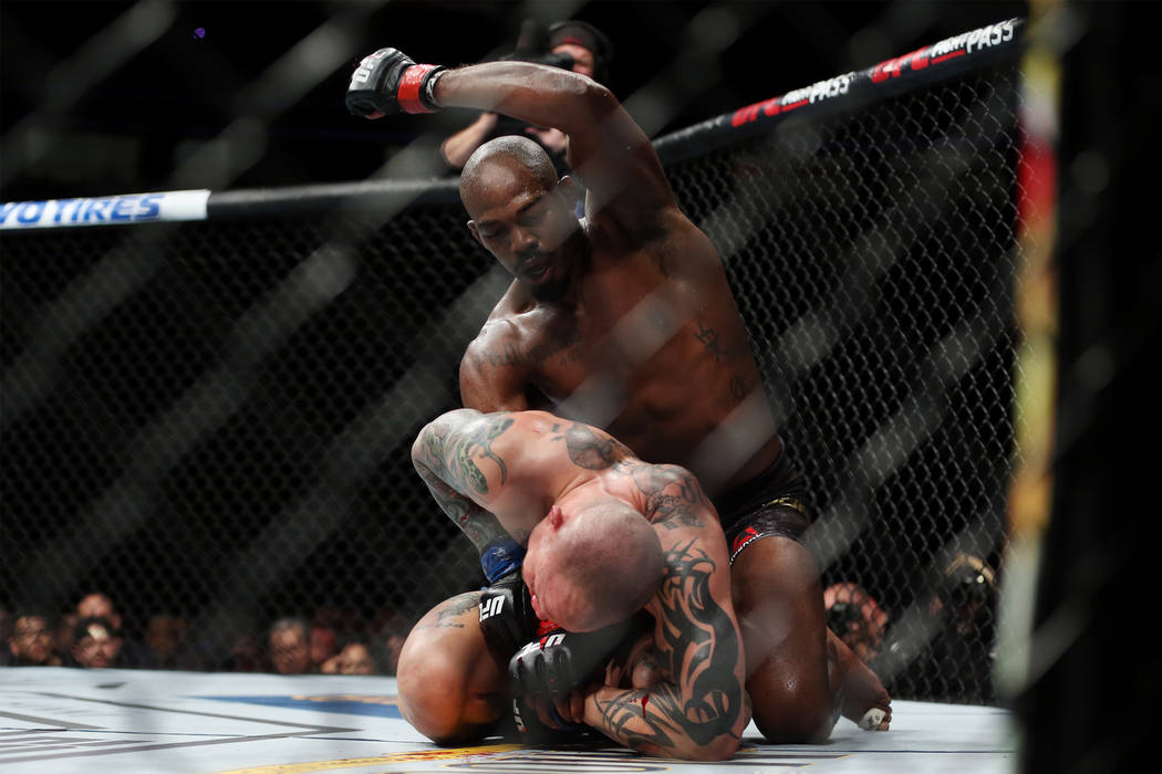 Jon Jones, top, throw a punch against Anthony Smith in the light heavyweight title bout during UFC 235 at T-Mobile Arena in Las Vegas, Saturday, March 2, 2019. Jones won by unanimous decision. (Er ...