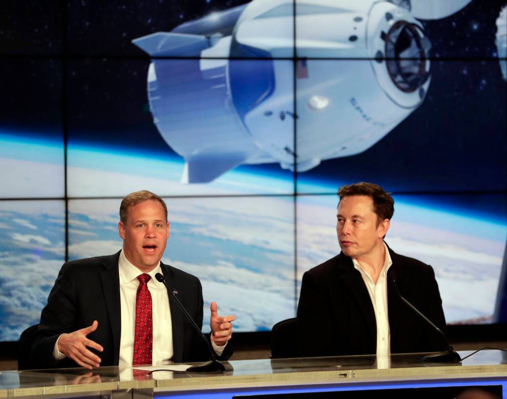NASA Administrator Jim Bridenstine, left, and Elon Musk, CEO of SpaceX, answer questions during a news conference after the SpaceX Falcon 9 Demo-1 launch at the Kennedy Space Center in Cape Canave ...