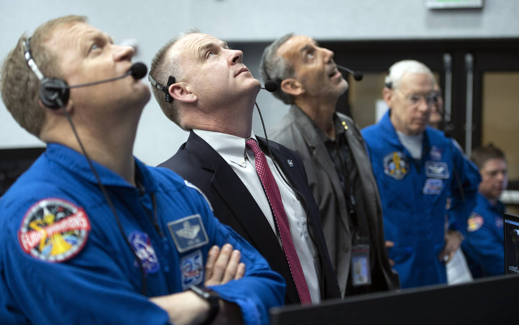 NASA astronaut Eric Boe, assistant to the chief of the astronaut office for commercial crew, left, and Norm Knight, deputy director of flight operations at NASA's Johnson Space Center watch the la ...