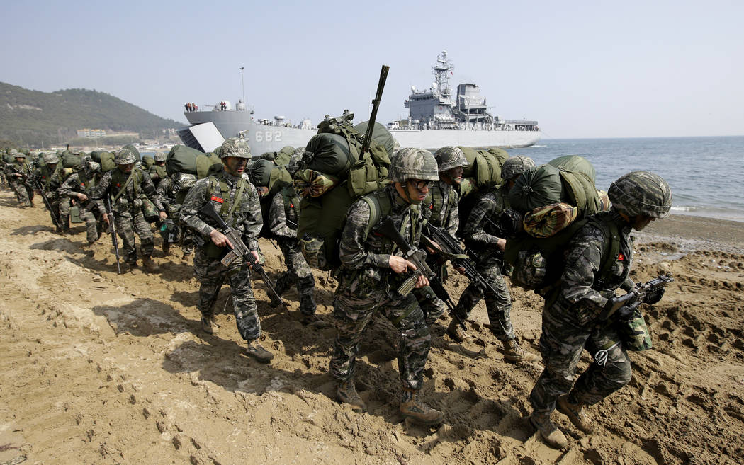 South Korean Marines march after landing on the beach during the U.S.-South Korea joint landing military exercises as a part of the annual joint military exercise Foal Eagle between South Korea an ...