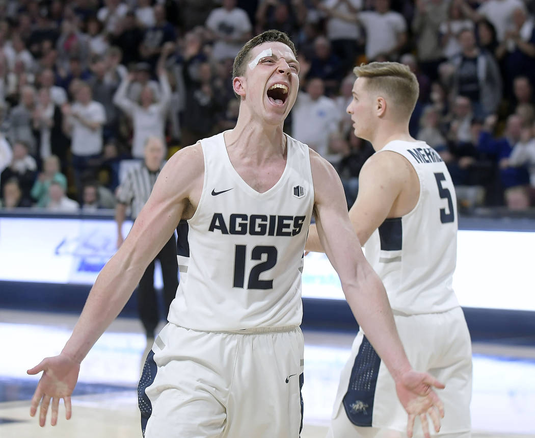 Utah State forward Justin Bean (12) celebrates after drawing a charge in the final minute against Nevada during an NCAA college basketball game Saturday, March 2, 2019, in Logan, Utah. (Eli Lucero ...