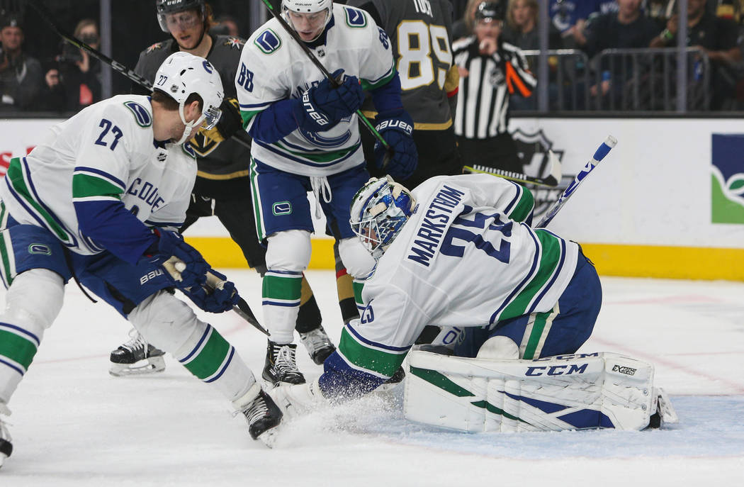 Vancouver Canucks goaltender Jacob Markstrom (25) blocks a shot from the Vegas Golden Knights during the first period of an NHL hockey game at T-Mobile Arenain Las Vegas, Sunday, March 3, 2019. (C ...