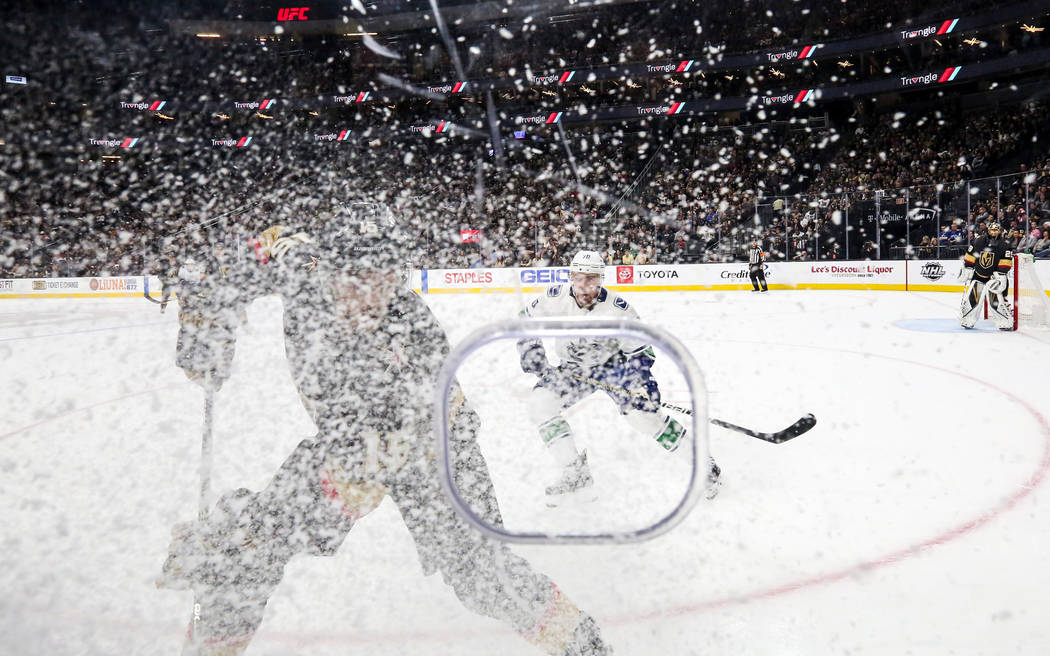 Vegas Golden Knights defenseman Jon Merrill (15) brushes up ice as he retrieves the puck during the second period of an NHL hockey game at T-Mobile Arena in Las Vegas, Sunday, March 3, 2019. (Caro ...