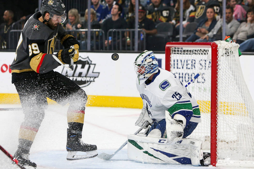Vegas Golden Knights right wing Alex Tuch (89) takes a shot against Vancouver Canucks goaltender Jacob Markstrom (25) during the first period of an NHL hockey game at T-Mobile Arenain Las Vegas, S ...