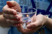 A family member of a passenger of Malaysia Airlines Flight 370, holds a candle during the Day of Remembrance for MH370 event in Kuala Lumpur, Malaysia, Sunday, March 3, 2019. Five years ago, Fligh ...
