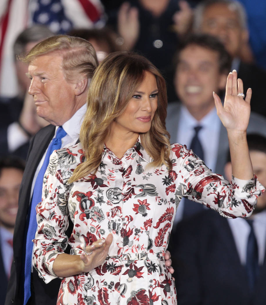 First lady Melania Trump, right, accompanied by President Donald Trump, waves before giving a speech to the Venezuelan American community at Florida International University in Miami, Monday, Feb. ...