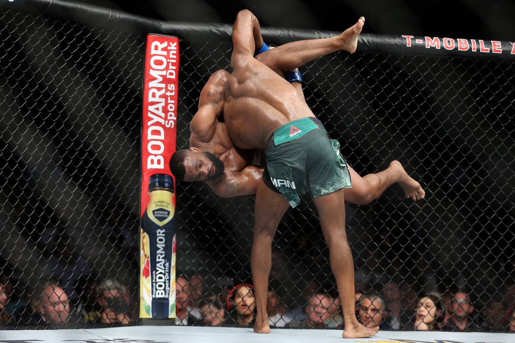 Kamaru Usman takes down Tyron Woodley in the welterweight title bout during UFC 235 at T-Mobile Arena in Las Vegas, Saturday, March 2, 2019. Usman won by unanimous decision. (Erik Verduzco/Las Veg ...