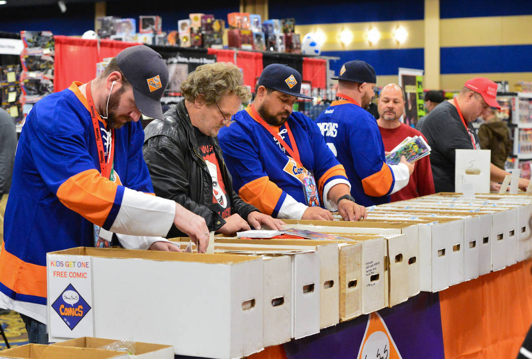 Conventiongoers and employees of ShimpSonS ComicS dig through boxes of comics at the Las Vegas Toy and Comic Convention at the Westgate Resort and Casino in Las Vegas, on Sunday, March 3, 2019. Br ...