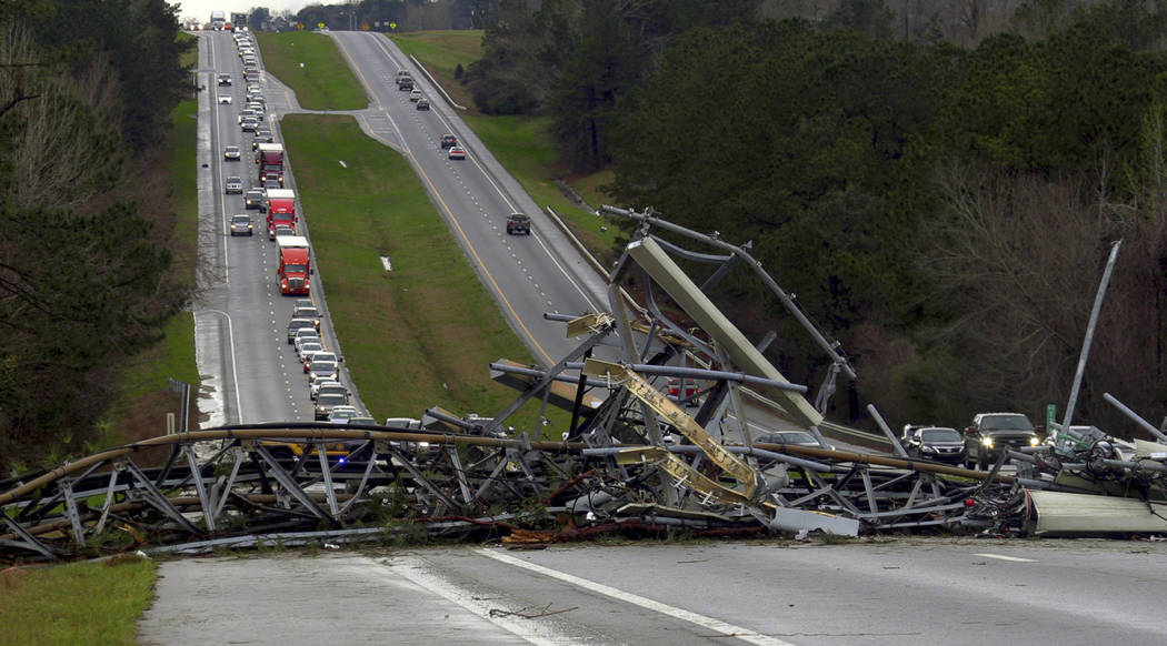A fallen cell tower lies across U.S. Route 280 highway in Lee County, Ala., in the Smiths Station community after what appeared to be a tornado struck in the area Sunday, March 3, 2019. Severe sto ...