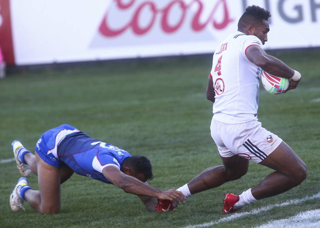 USA's Matai Leuta (4) scores a try past Samoa's Alamanda Motuga (2) while competing in the Cup Final during the USA Sevens Rugby Tournament at Sam Boyd Stadium in Las Vegas on Sunday, March 3, 201 ...